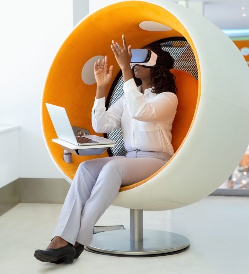 Focused woman testing VR headset. Thoughtful African American tester wearing virtual reality glasses. Technology concept